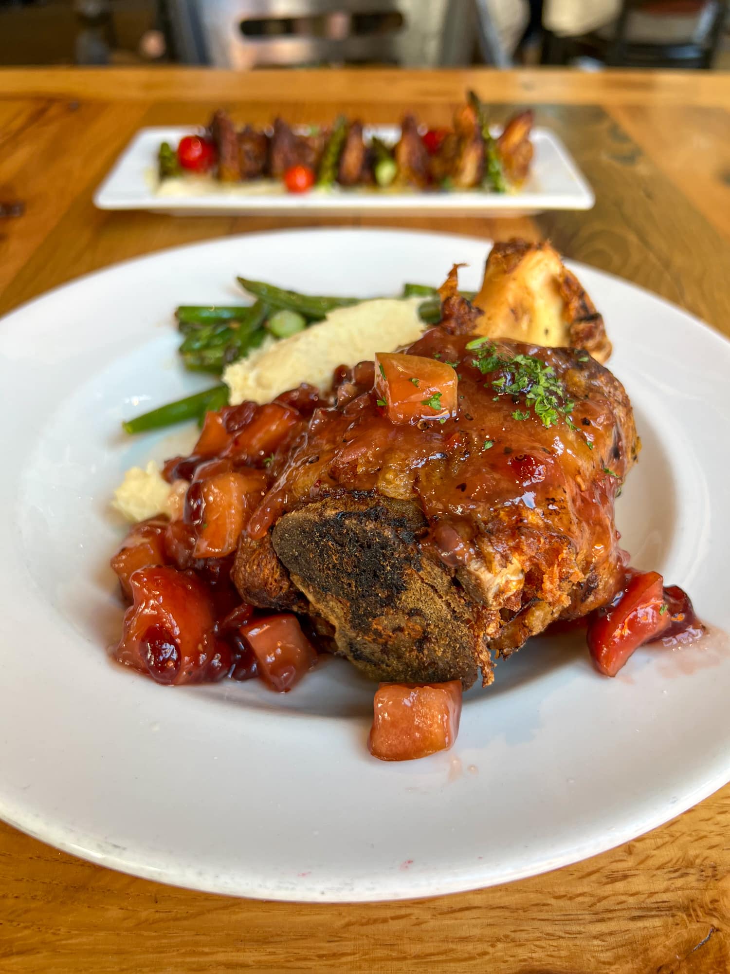 Compart Family Duroc pork shank with firecracker apple-cranberry-raisin chutney at Ulele, a Michelin Guide recommended restaurant in Tampa, Florida.