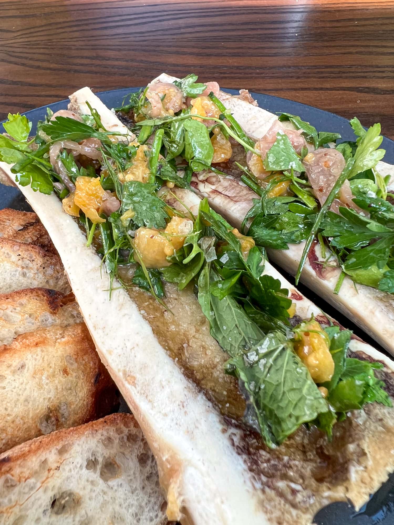 Bone marrow with herb salad and baguettes