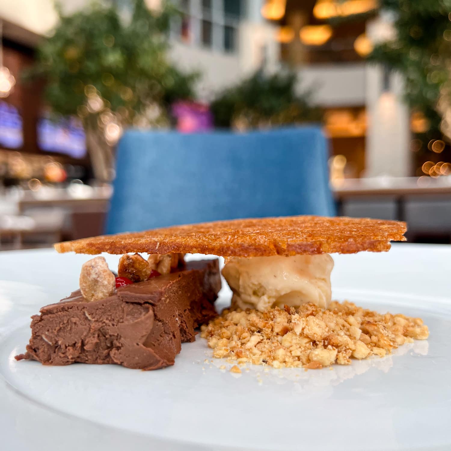 Chocolate cremeux with raspberry couli, peanuts, candied baguette, and vanilla ice cream