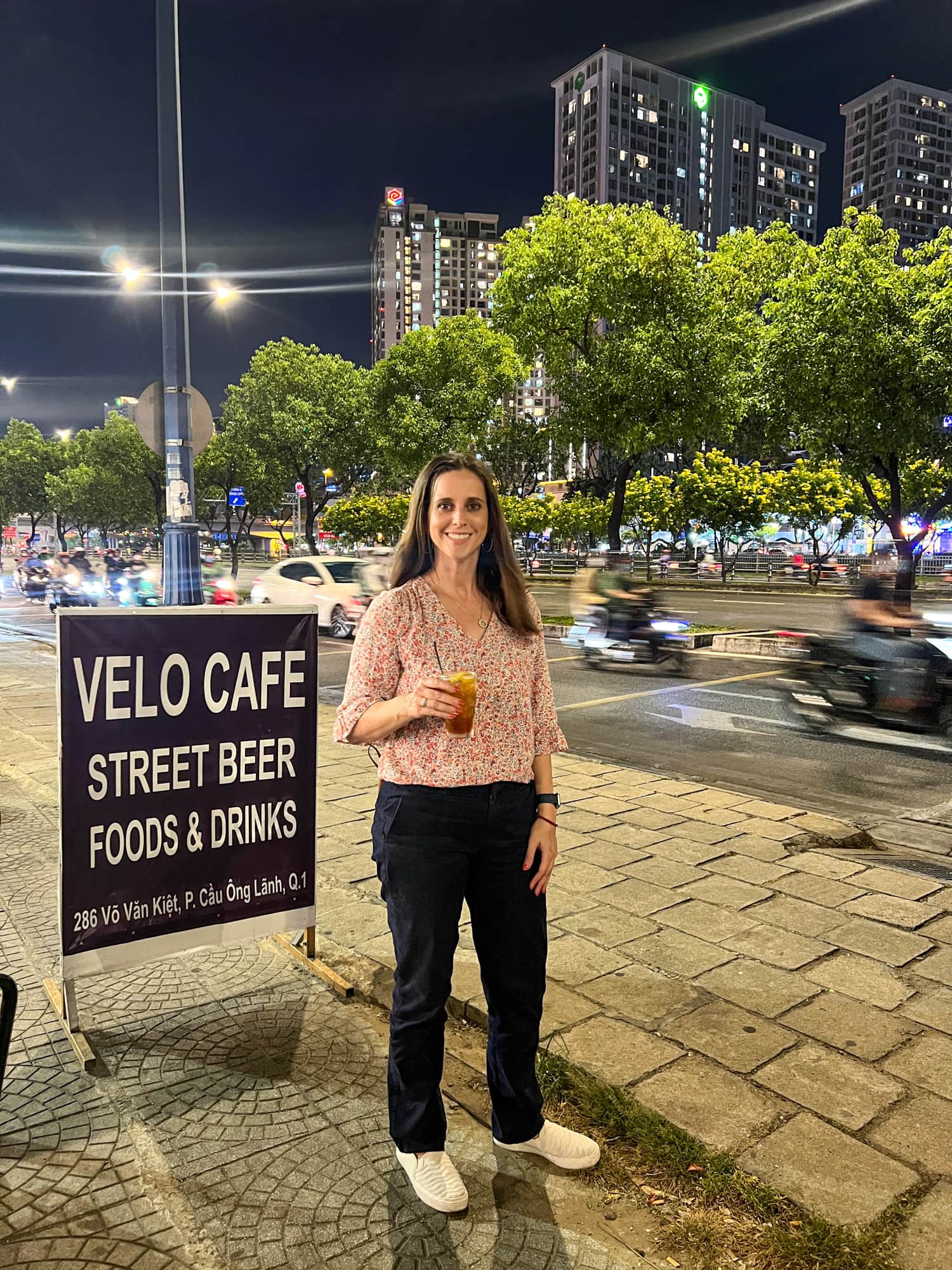 Kel with a kumquat iced tea at Velo Cafe during our Saigon food tour