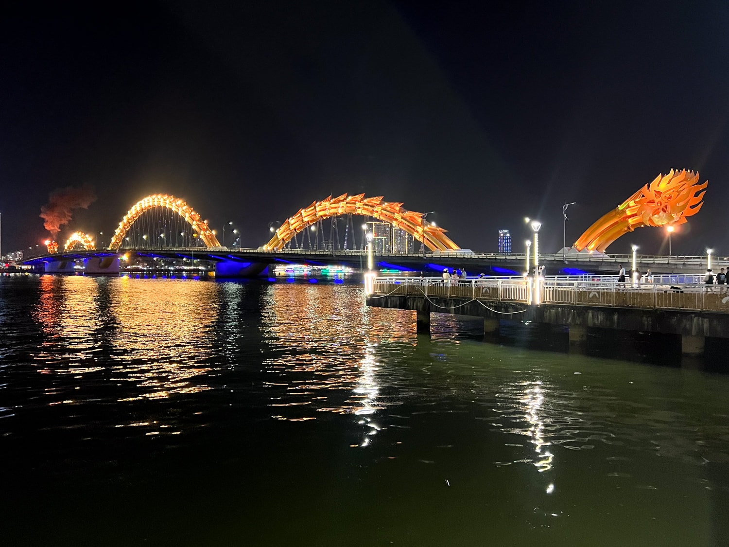 The Dragon Bridge breathing fire at night in Da Nang