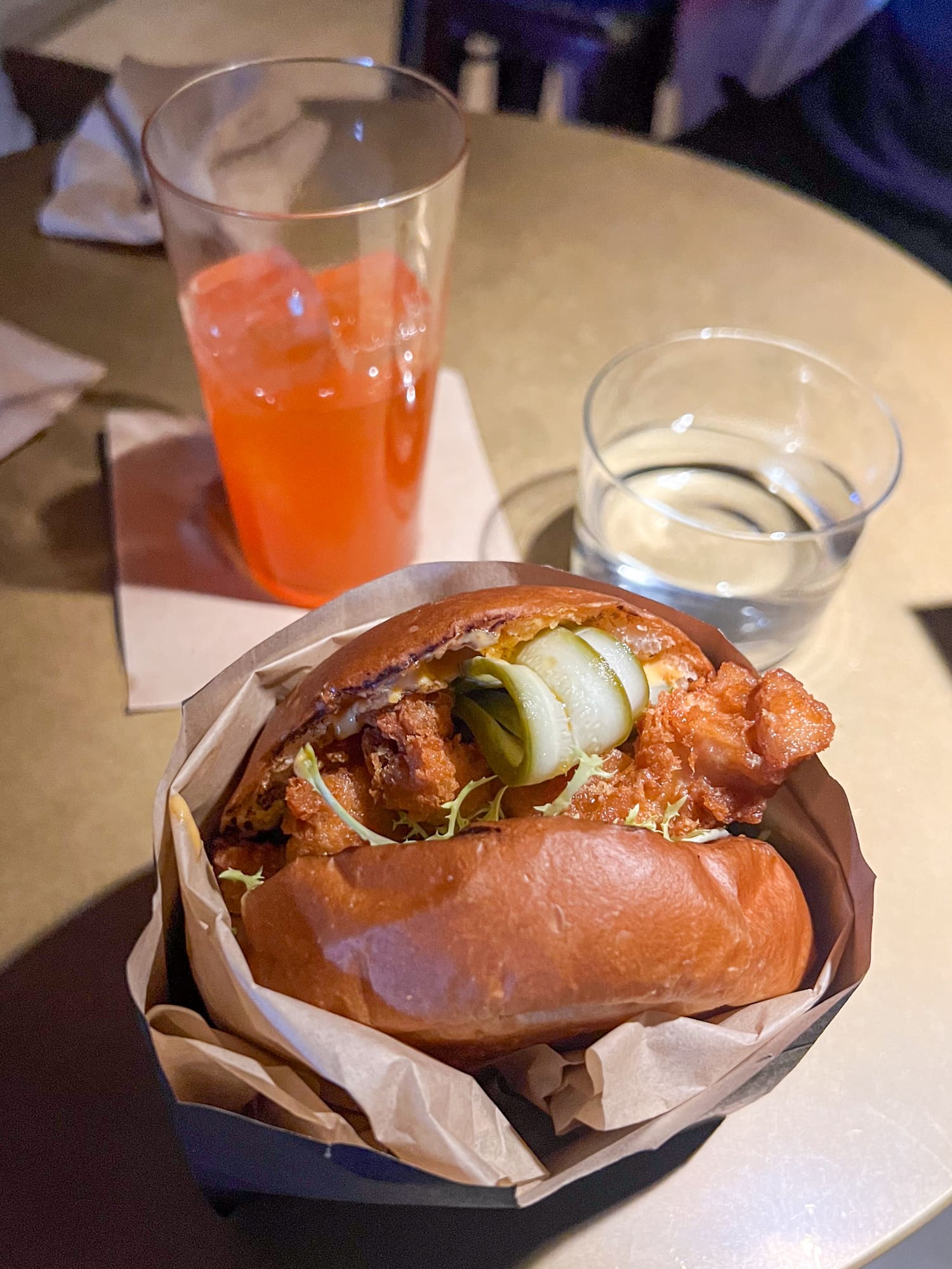 Salted egg yolk chicken sandwich and Aperol cocktail