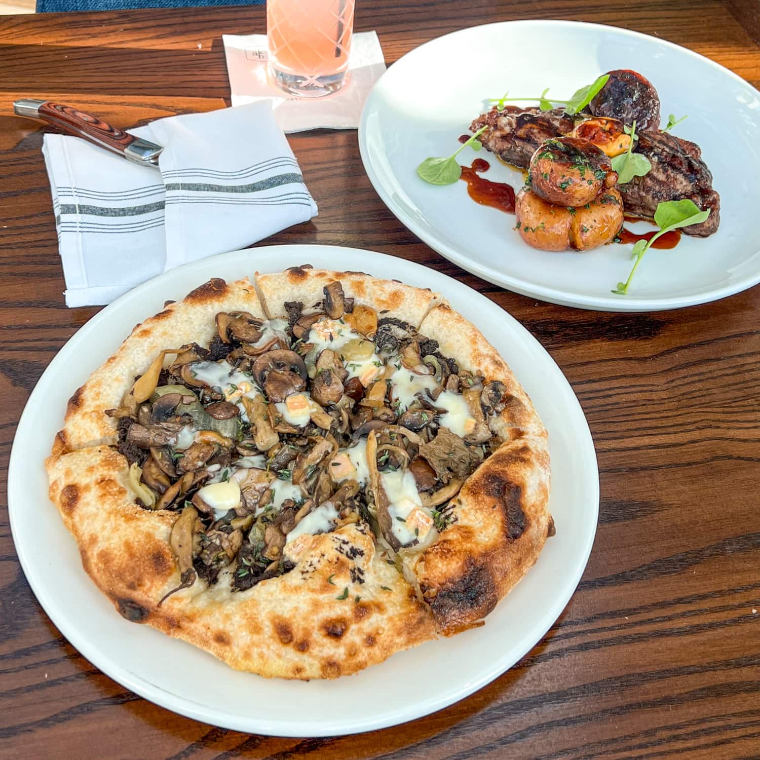 Mushroom pizza and steak at AKB Hotel Bar, a new restaurant at The Domain in Austin, TX.