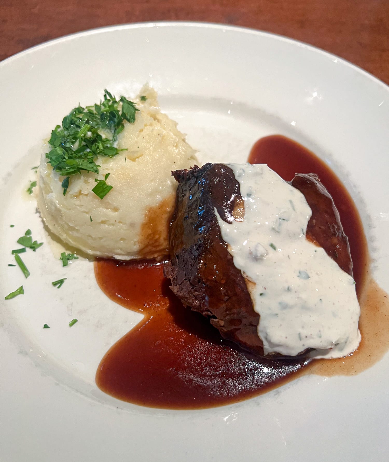 Braised short ribs with horseradish cream, housemade beef jus, and mashed potatoes at Paul Martin's American Grill, one of the best restaurants at The Domain in Austin, TX.