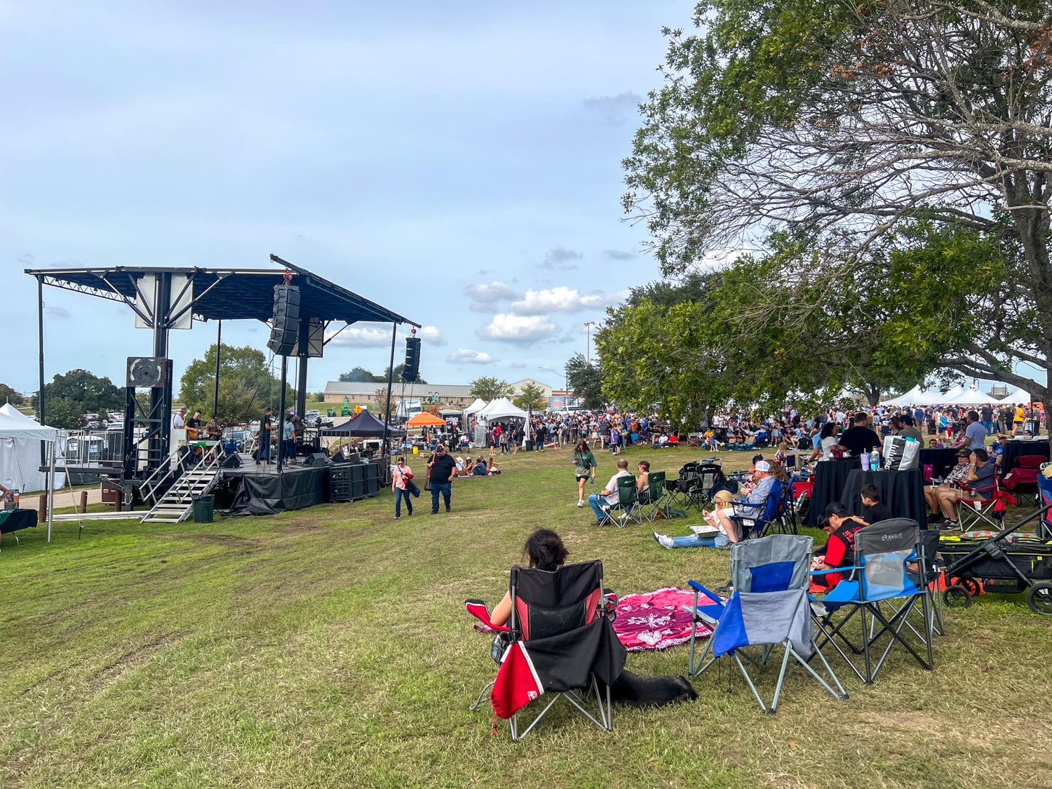 Stage and attendees at the Texas Monthly BBQ Fest in Lockhart City Park