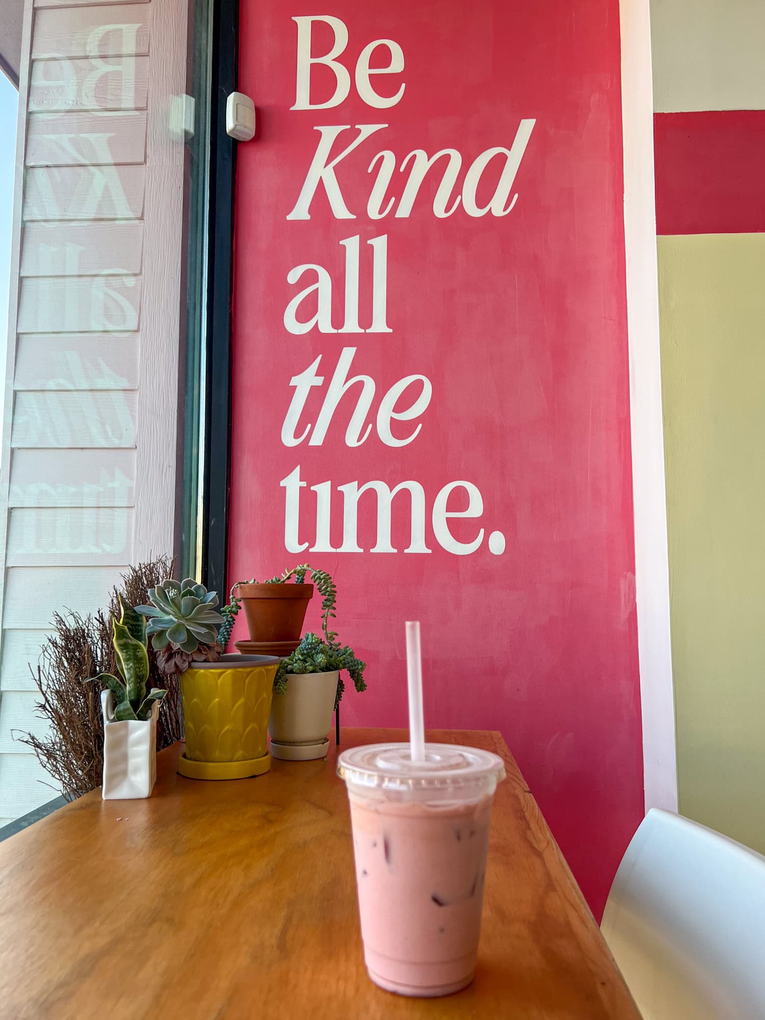Iced pink horchaita made with strawberry, chai, and breve at Be Kind Coffee.