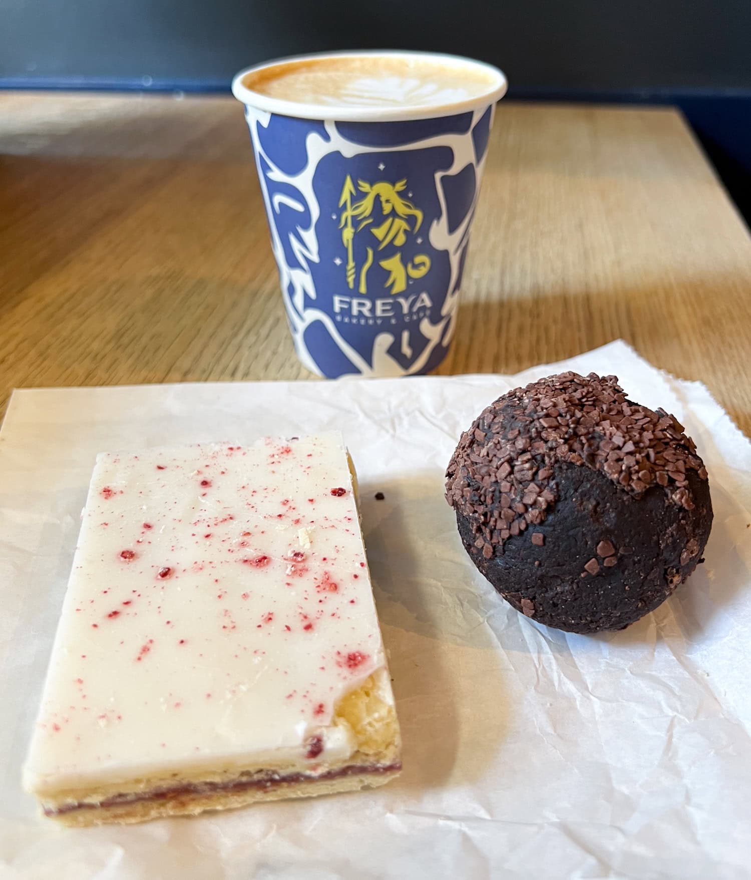 Raspberry slice, rum ball, and a Dubai chocolate latte at Freya Bakery & Cafe.