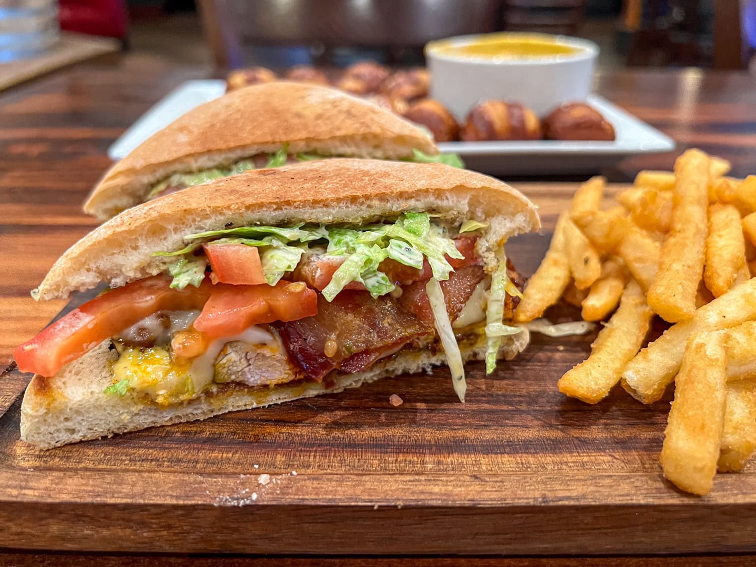 Chicken sandwich with French fries.