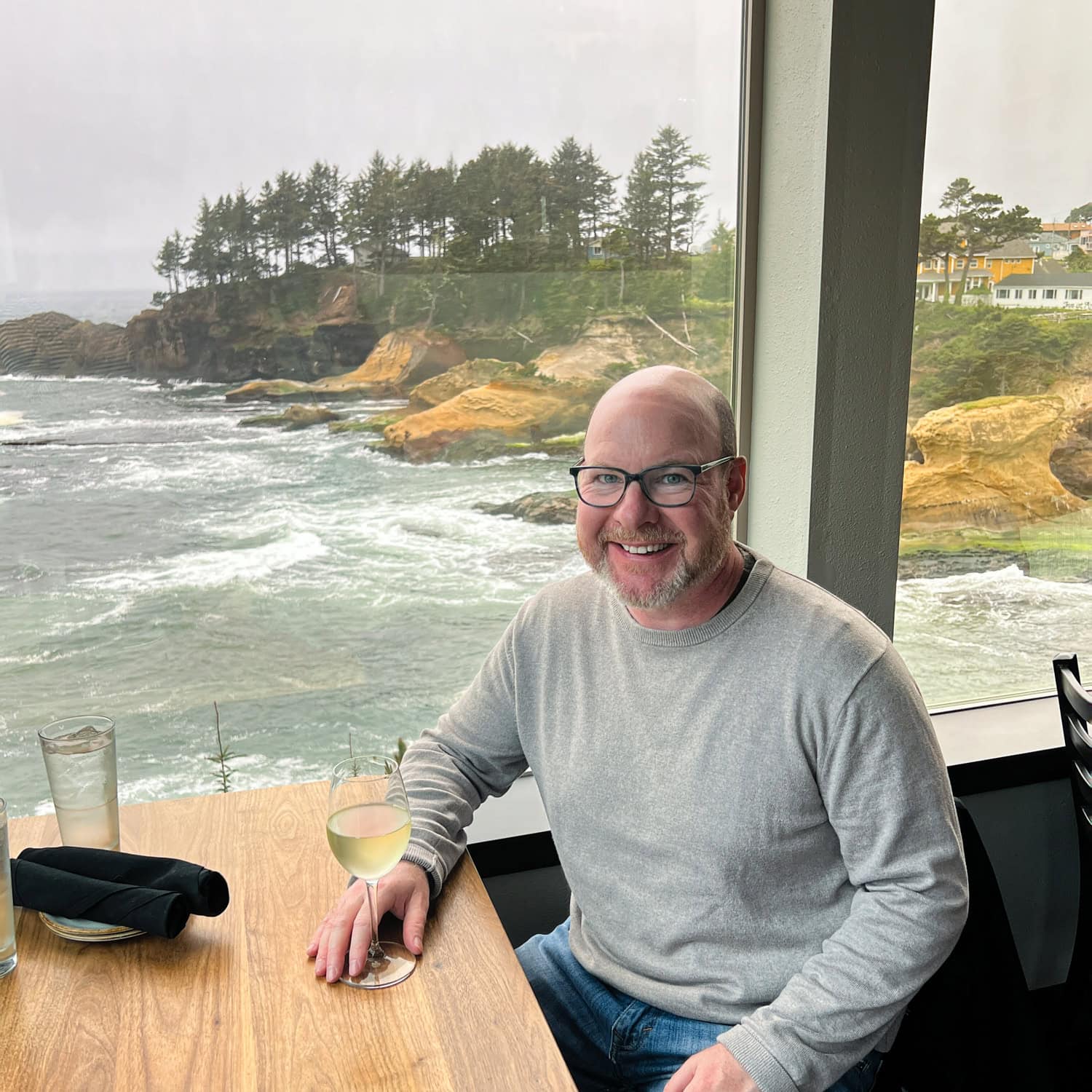 Enjoying a glass of local white wine in Depoe Bay during my Oregon Coast road trip (photo by Kelly Lemons).