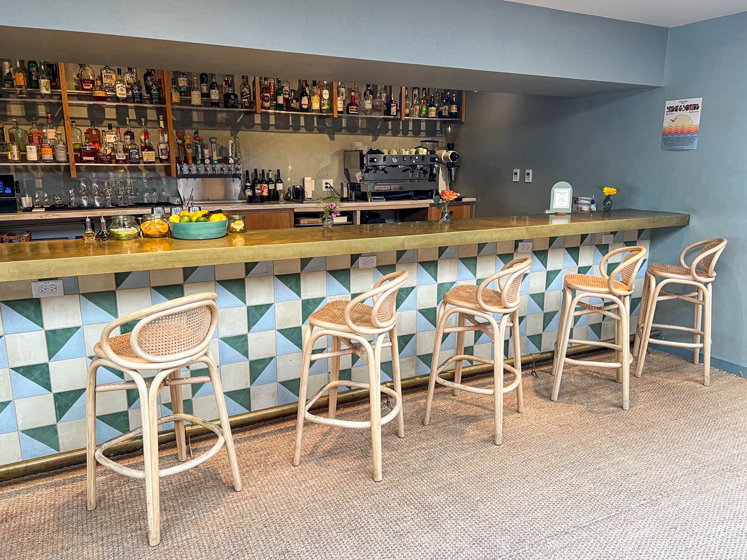 A tiled bar in The Den takes orders for coffee, drinks, and food.