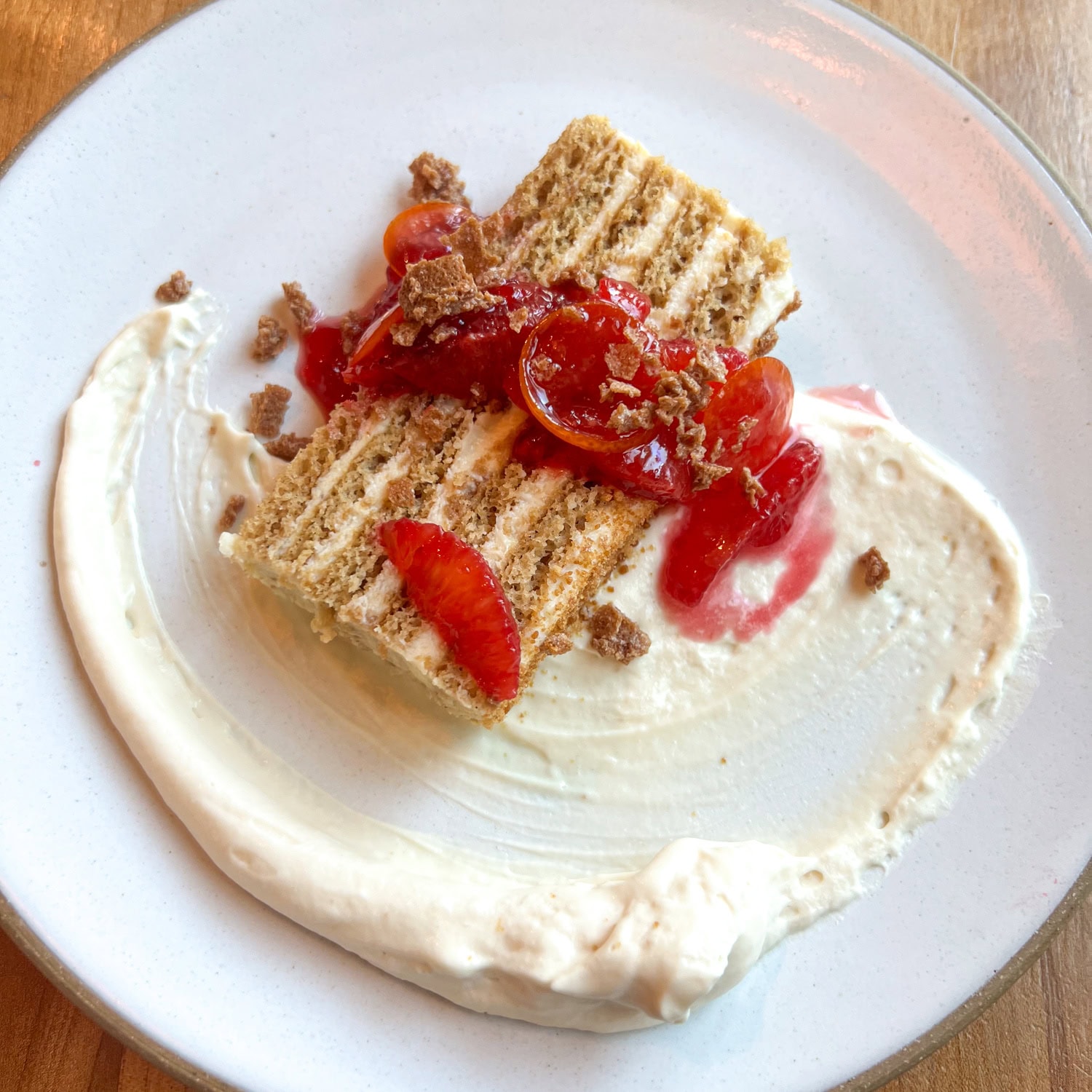 Honey cake with whipped crème fraîche, burnt honey mousse and blood orange glazed kumquat.