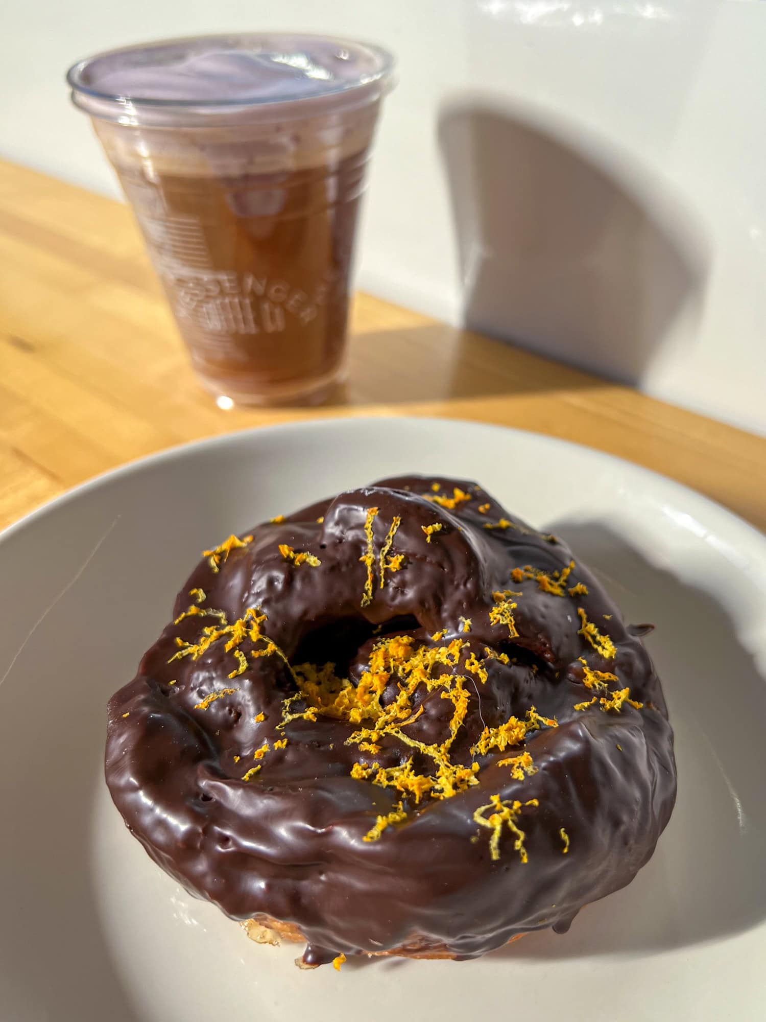 Chocolate orange croissant bun and a dragon fruit cold foam cold brew.