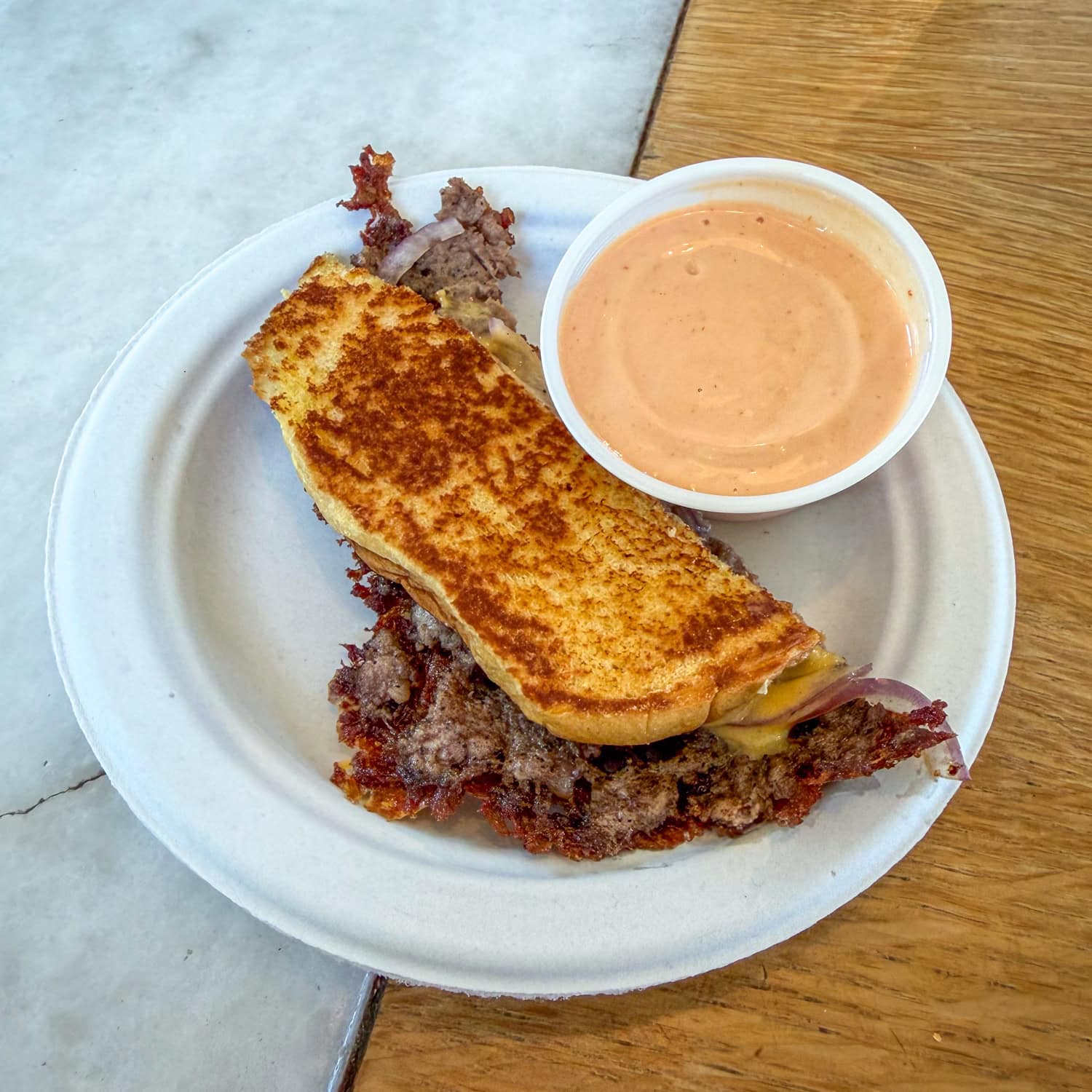 A sample of Joyland's signature Crustburger with sauce on the side.
