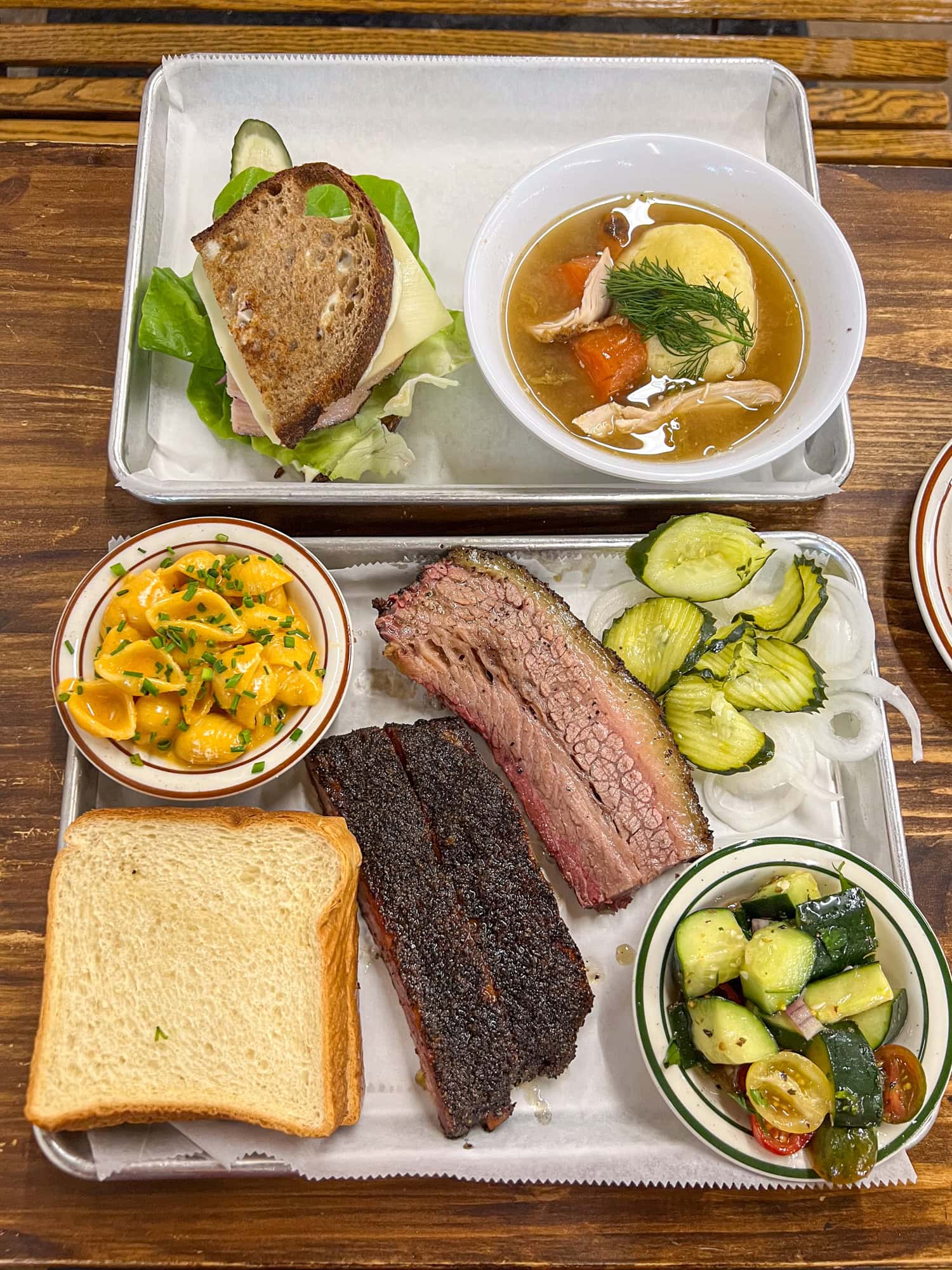 Two-meat plate with brisket and pork ribs, with Mac n cheese and tomato cucumber salad.
