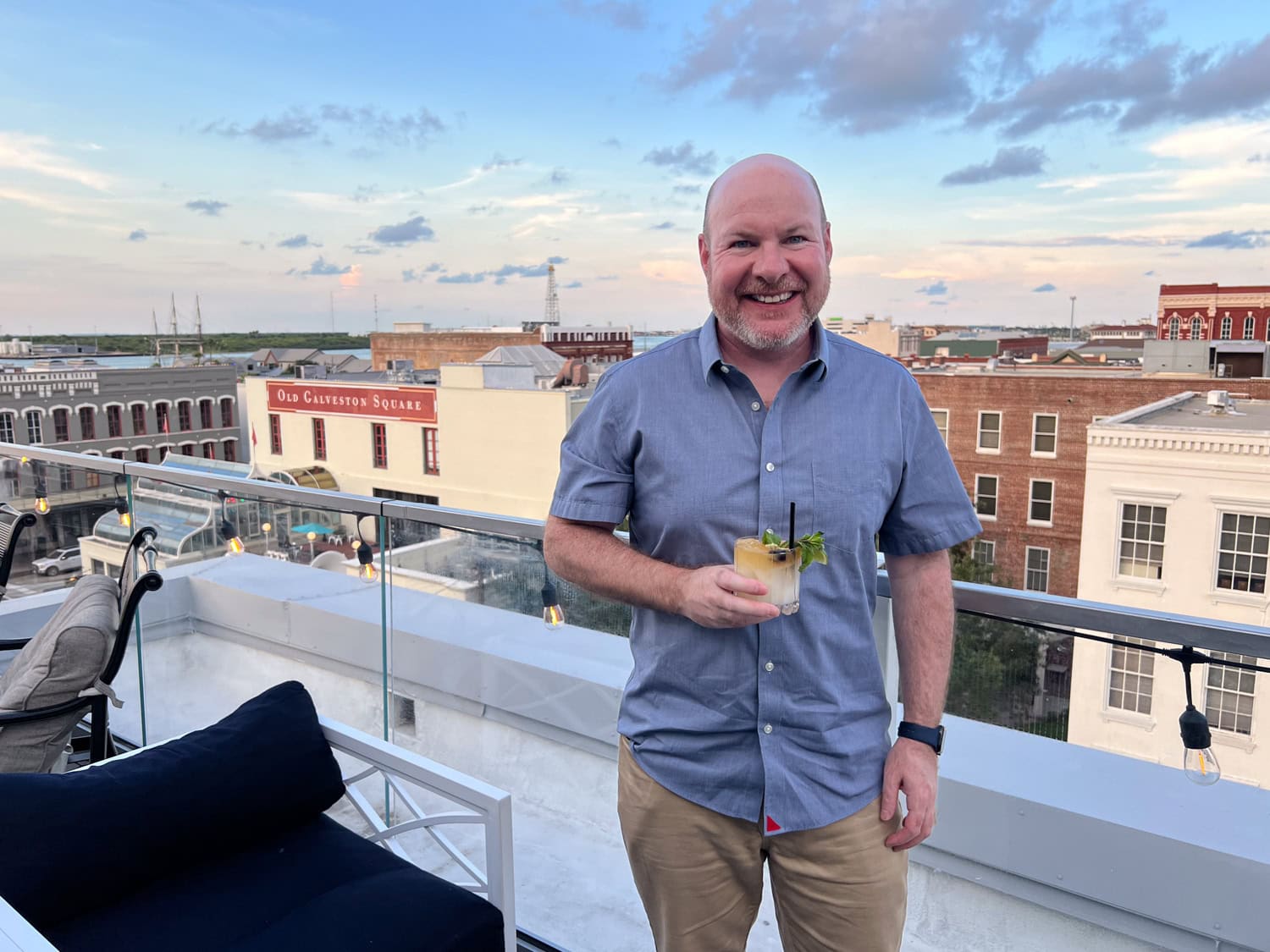 Dave with cocktail in hand on the rooftop bar at the Tremont House Hotel in Galveston, Texas (photo by Kelly Lemons).