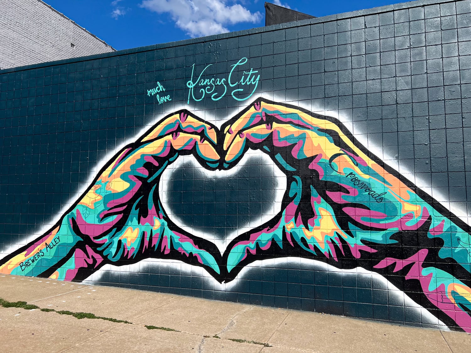 Kansas City mural with two hands forming a heart in the Crossroads Arts District.