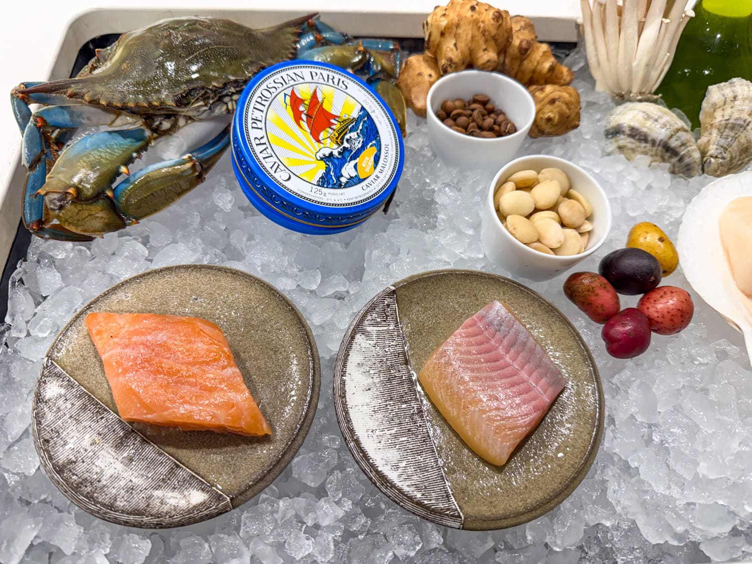 Crab, fish, and caviar on ice in Emeril's restaurant kitchen.