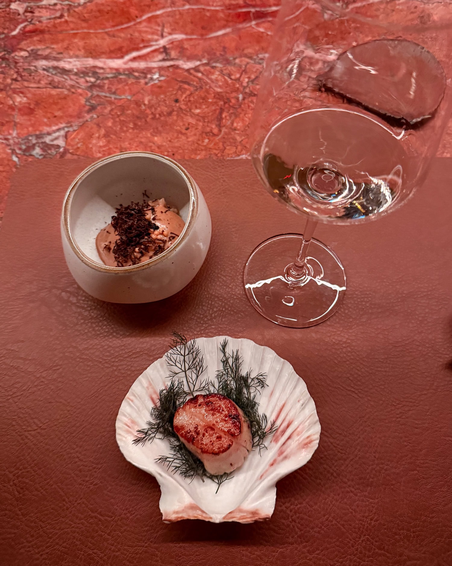 Hokkaido scallop served in a shell with pecan miso custard topped with black truffle and a sake pairing at Anbā