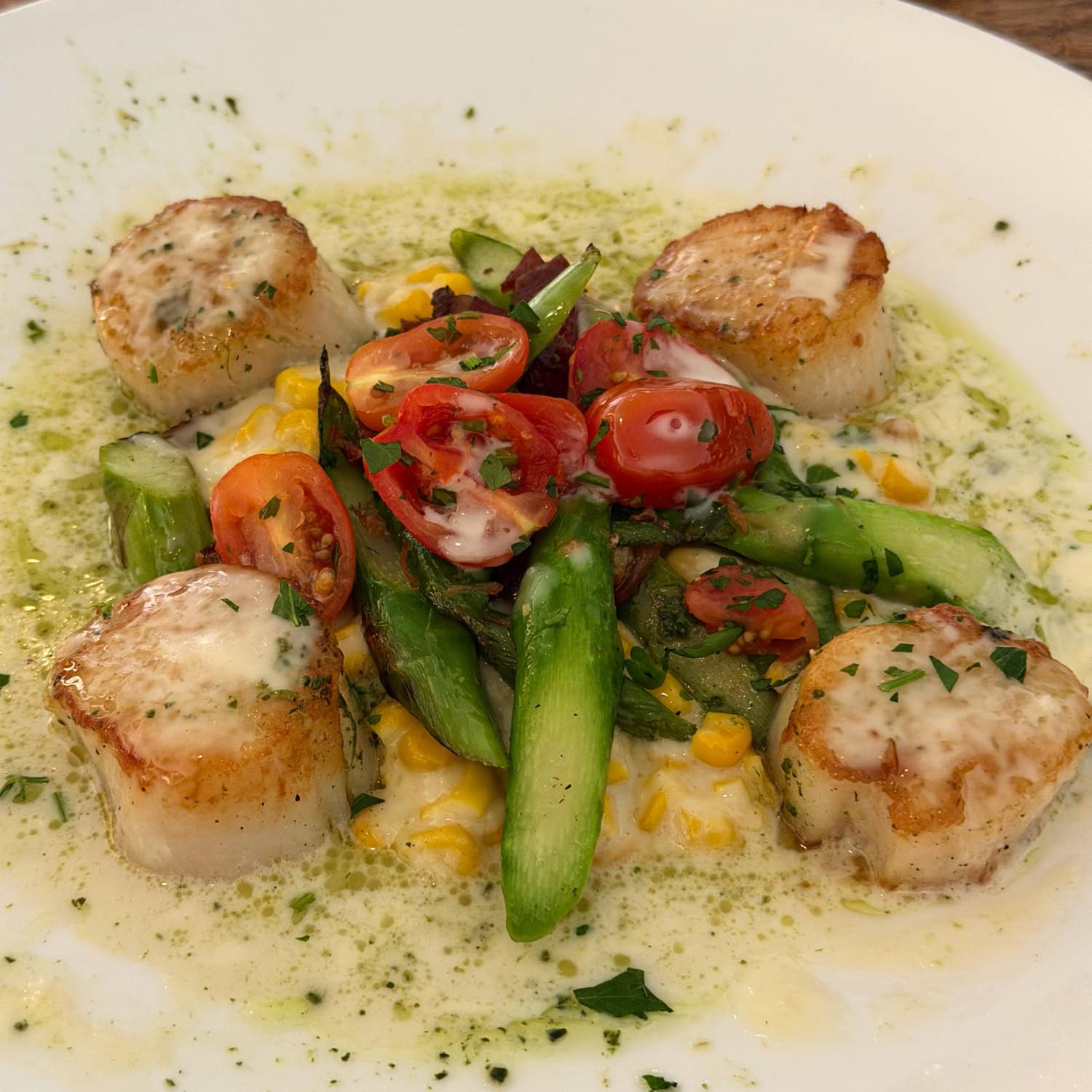 Diver scallops with creamed corn, asparagus, and cherry tomatoes at Beach House Restaurant on Kauai
