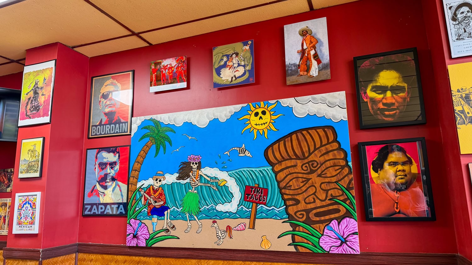 Colorful interior wall art at Tiki Tacos in Kapa'a featuring an Anthony Bourdain portrait