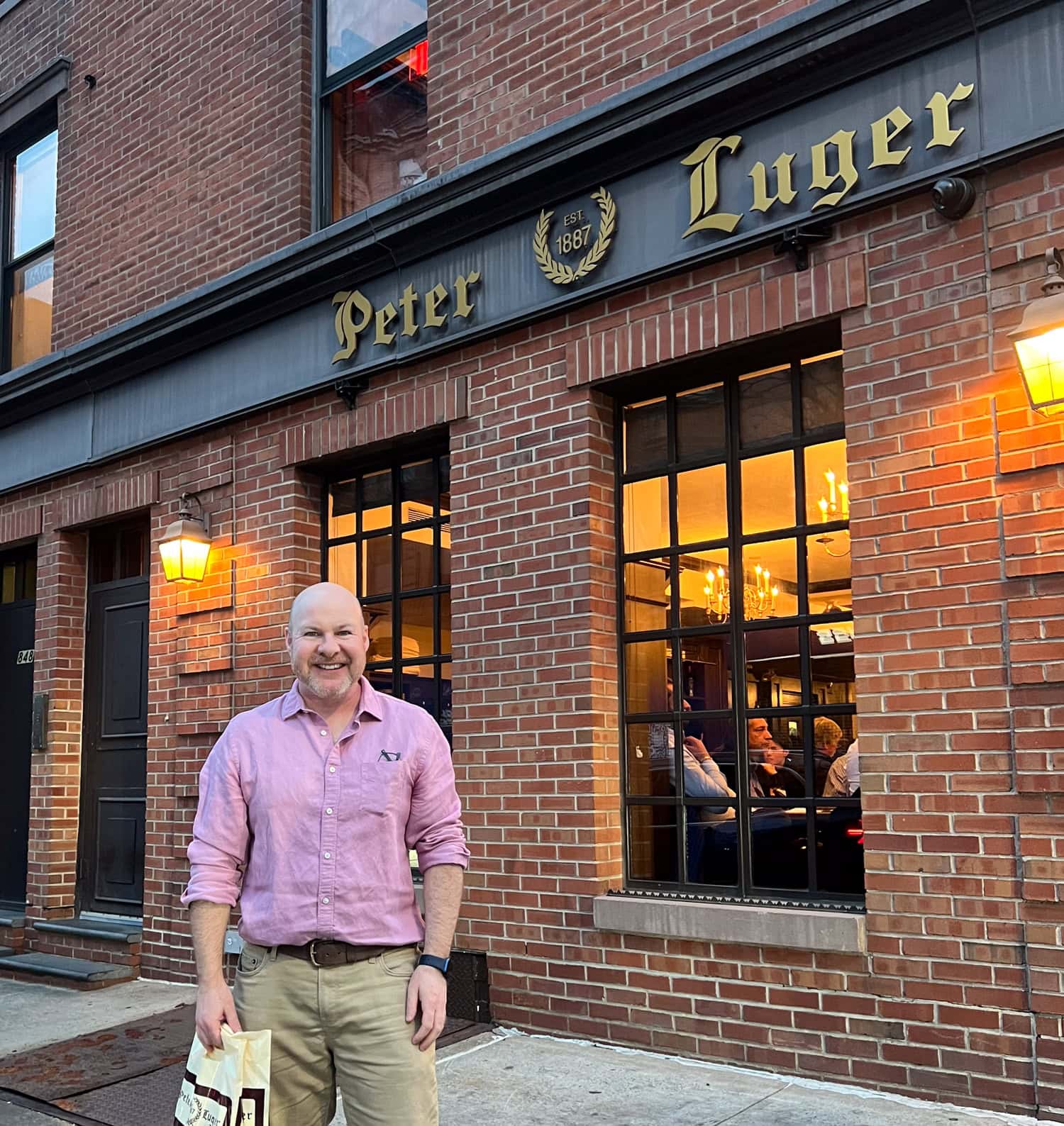 Dave standing outside Peter Luger Steak House in Brooklyn, New York.