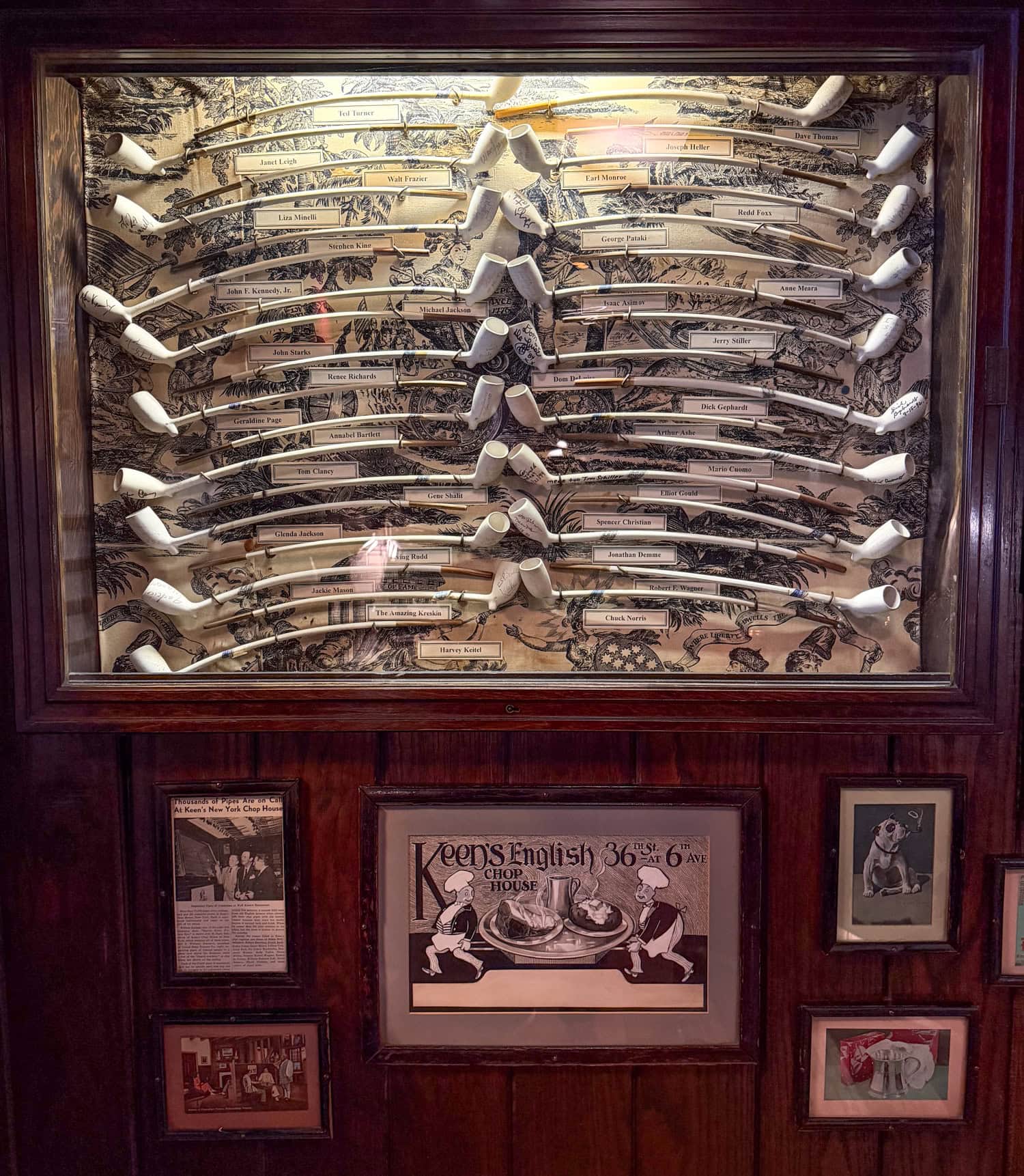 Historic churchwarden pipe collection displayed inside Keens Steakhouse.