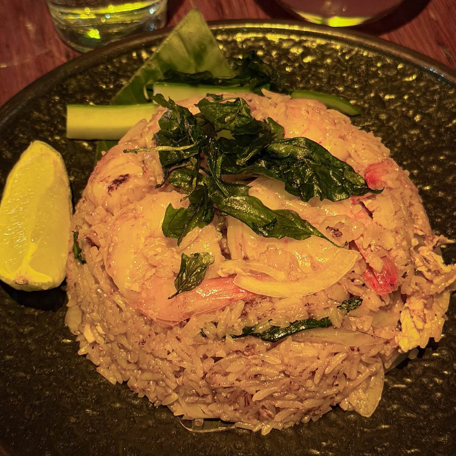 Plate of shrimp basil fried rice topped with crispy basil at OBAO, a NYC restaurant.