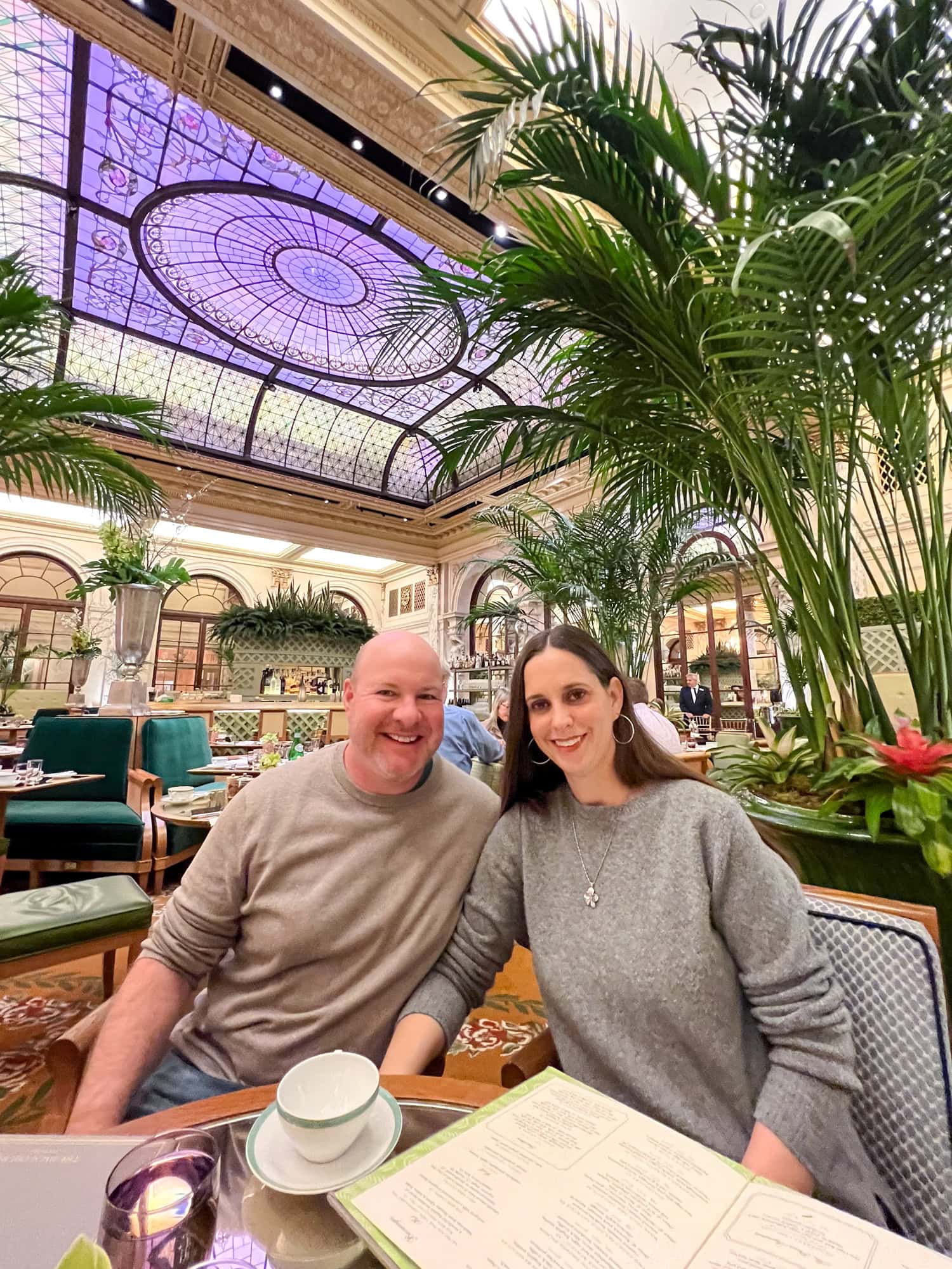 Dave and Kel seated inside The Palm Court at The Plaza Hotel in New York City