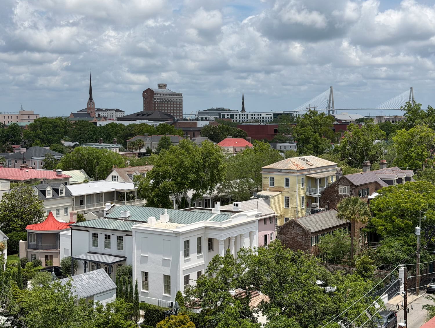 View of the Charleston skyline with historic homes and the Arthur Ravenel Jr. Bridge