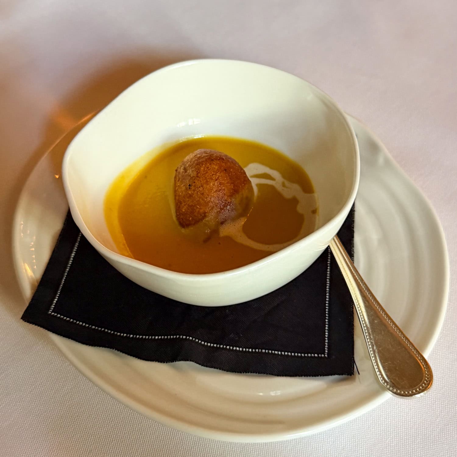 Butternut squash and coconut curry amuse-bouche with a pancetta hush puppy