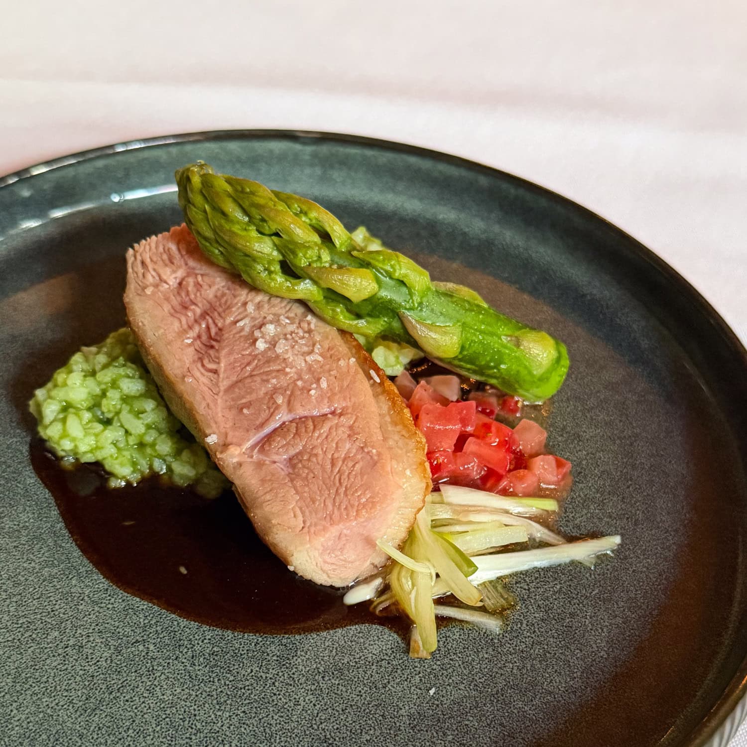 Duck breast with asparagus, vegetables, and sauce served at Circa 1886 Restaurant in Charleston.