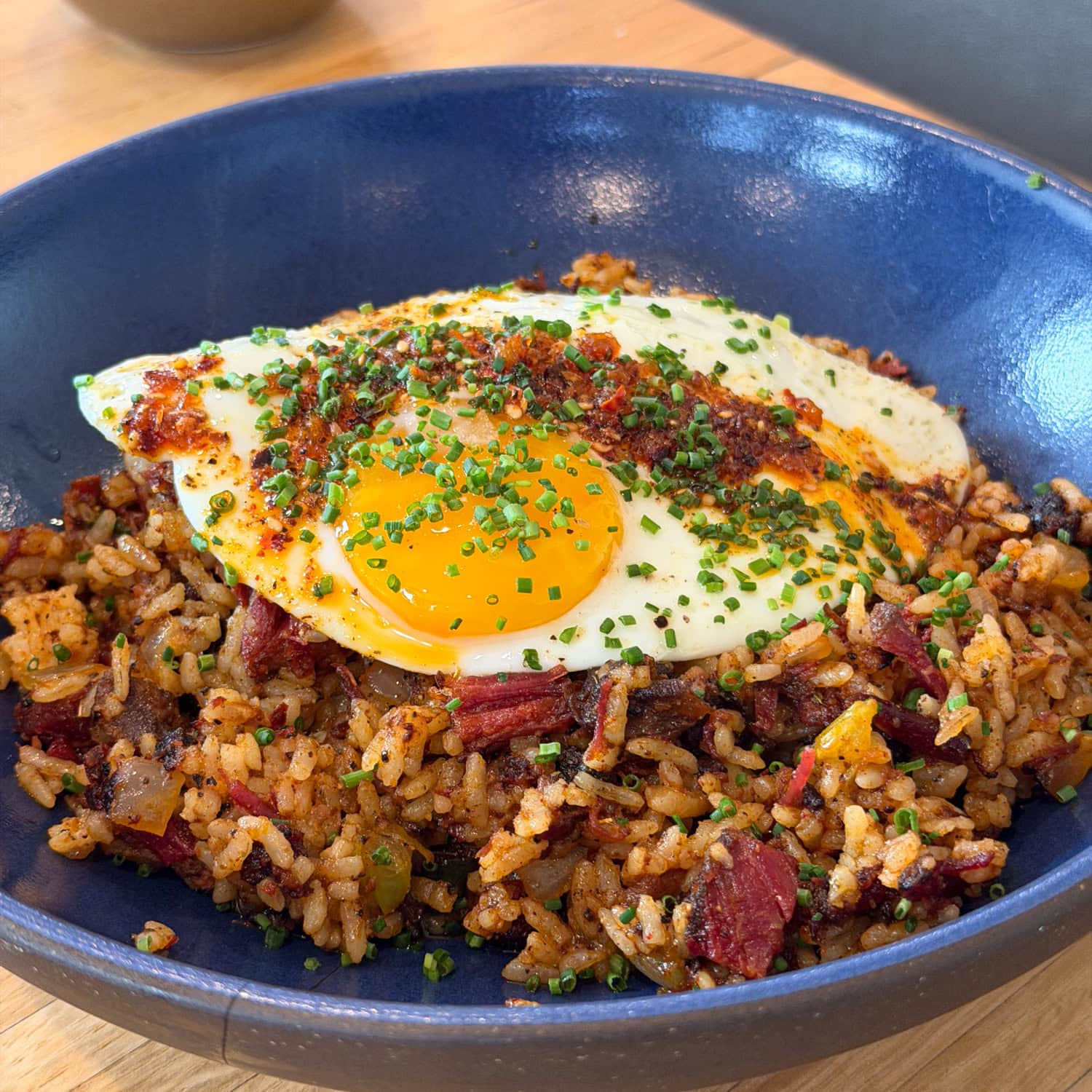Pastrami brisket dirty rice with fried egg and chili crisp at Husk