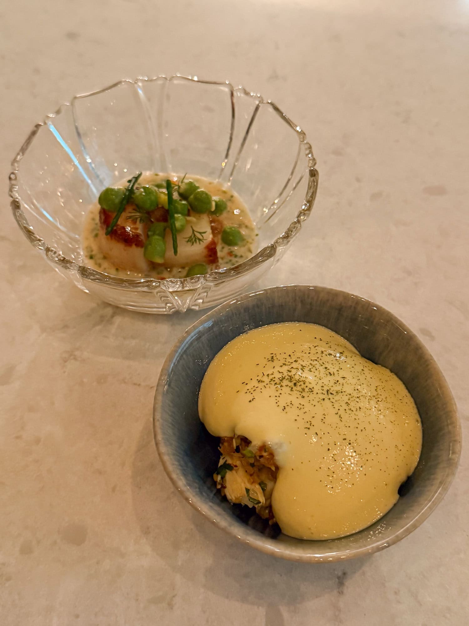 A course of seared scallops and crab rice served at Wild Common in Charleston