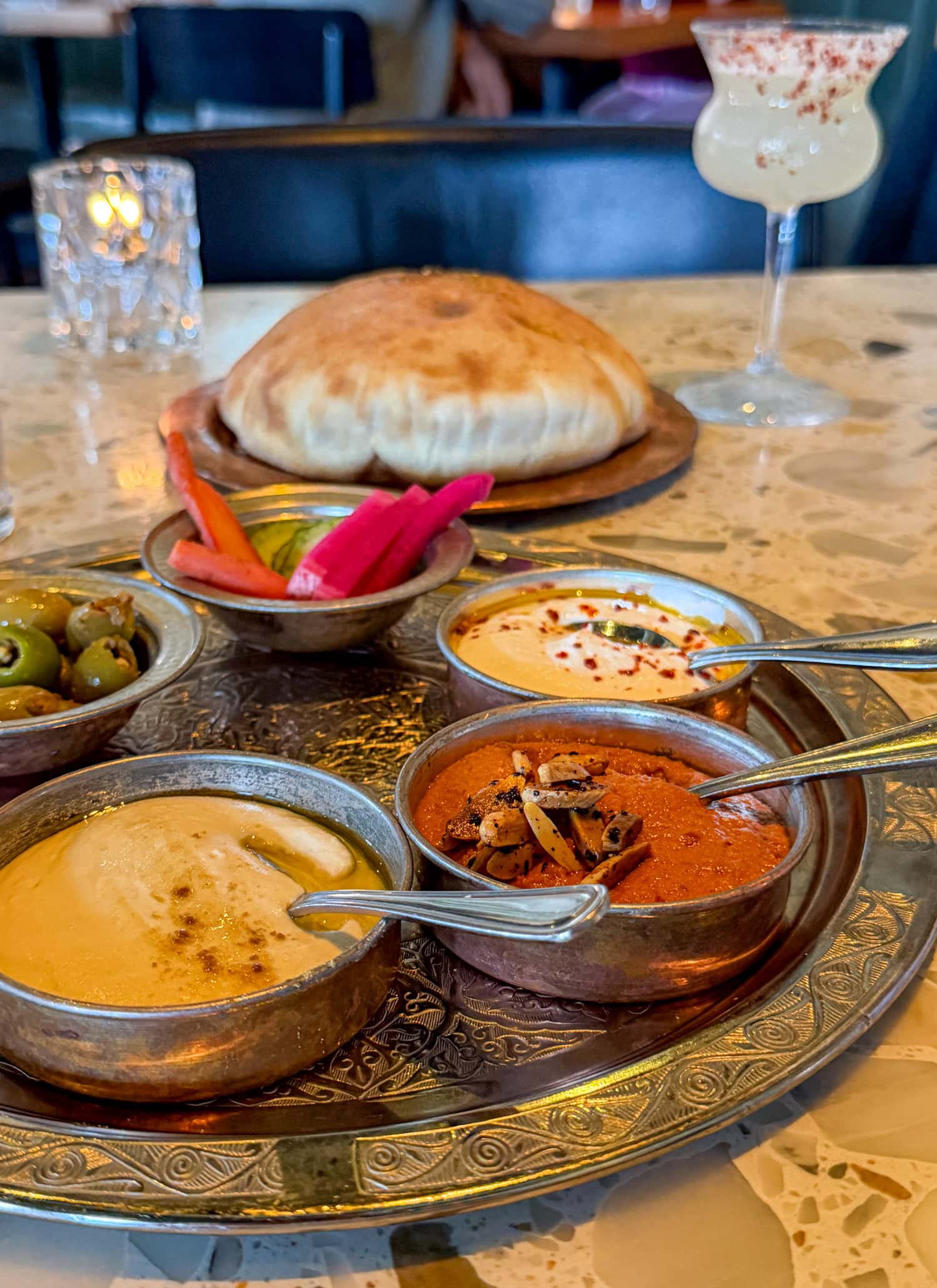 Breaking Bread appetizer at Dalida with warm pita, dips, olives, and pickled vegetables