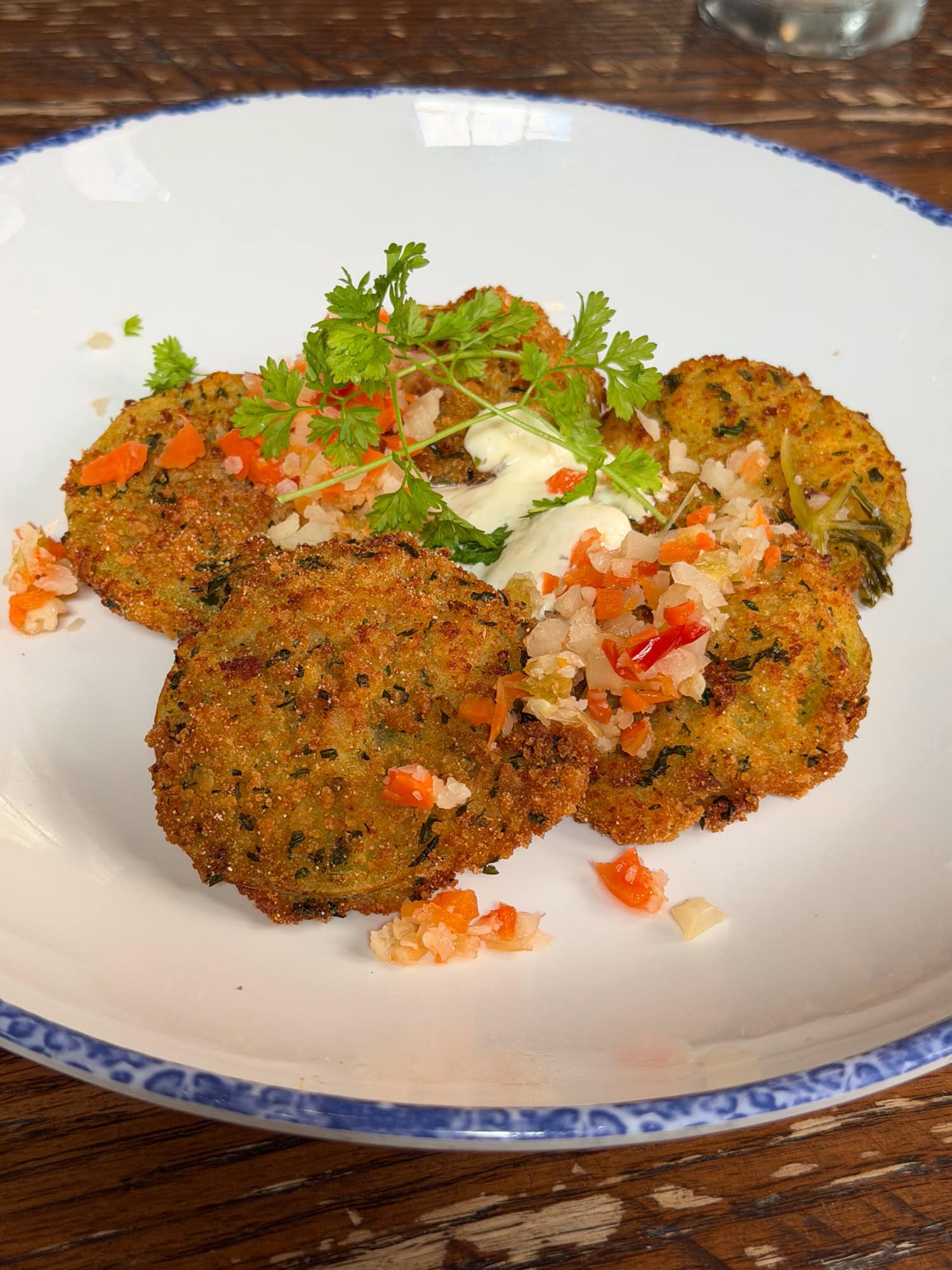 A plate of fried green tomatoes with remoulade and relish at Poogan's Porch