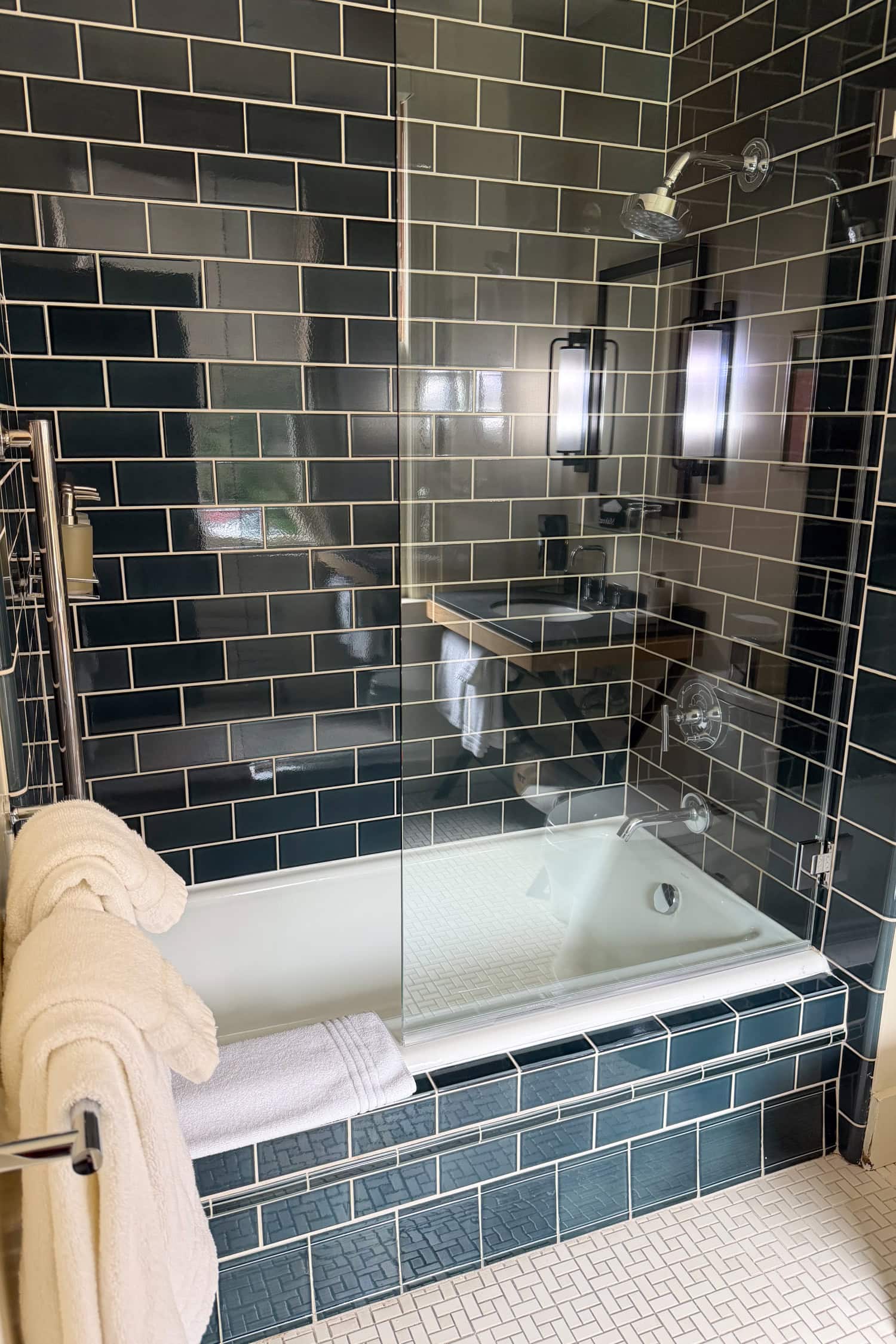 Shower and bathtub with dark subway tile in a Classic King Suite at the Inn at the Presidio