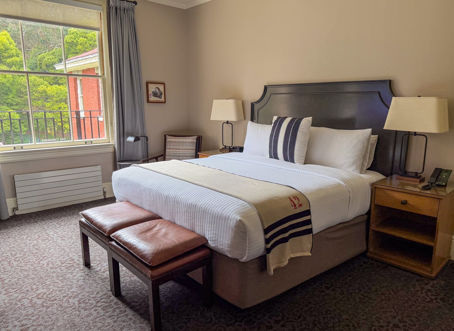 Classic King Suite bedroom at the Inn at the Presidio with a king bed and large window