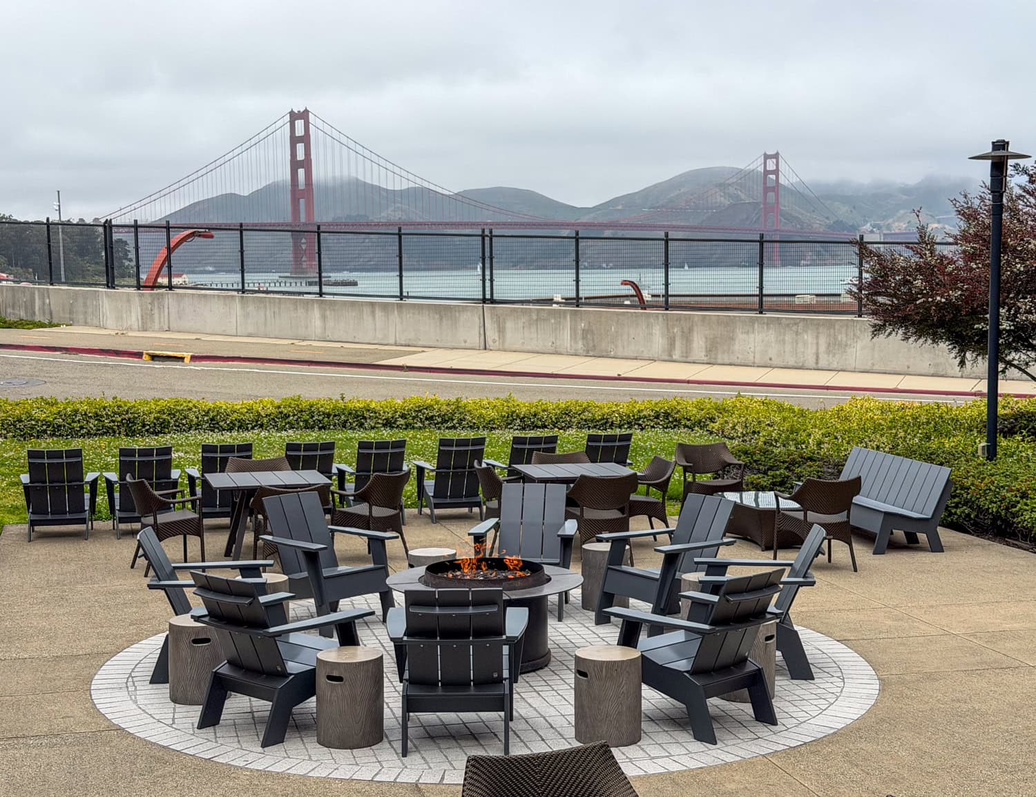 Gas firepit at the Lodge at the Presidio with the Golden Gate Bridge in the distance