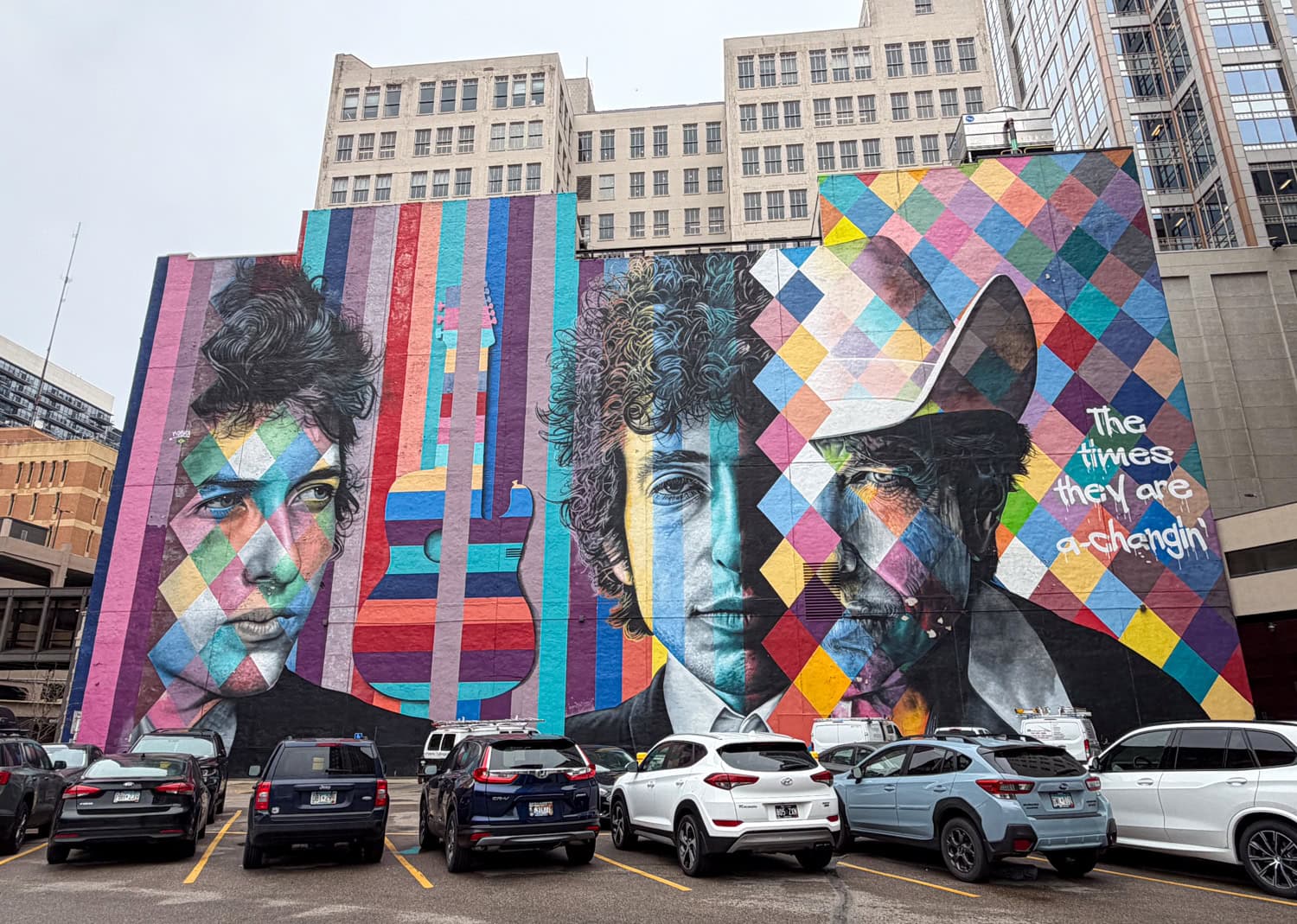 Colorful Bob Dylan mural overlooking a parking lot in downtown Minneapolis