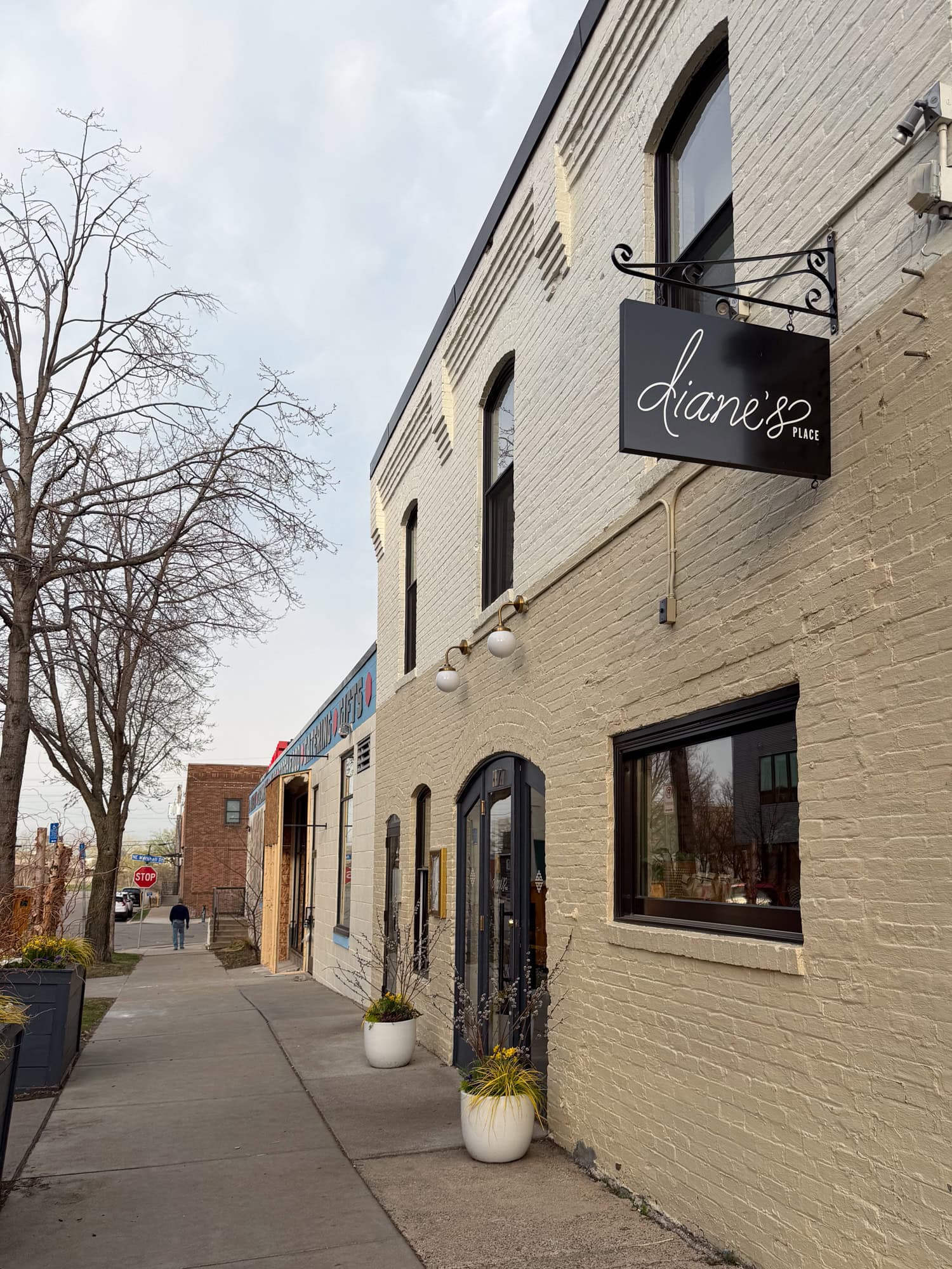 Exterior of the Food Building in Northeast Minneapolis with a black Diane's Place sign above the entrance.