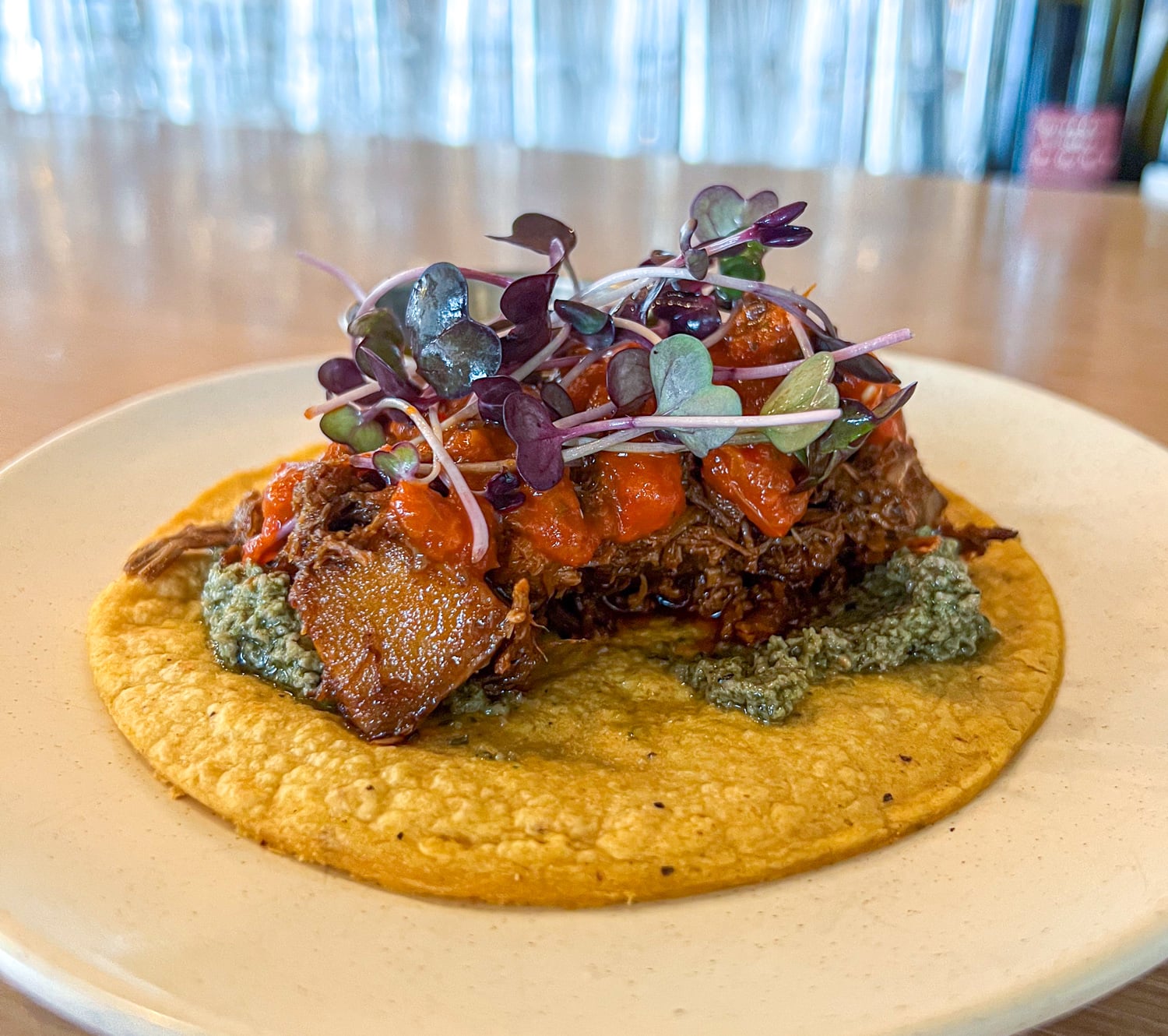 Bison birria taco with guajillo salsa and spring pesto at Owamni in Minneapolis