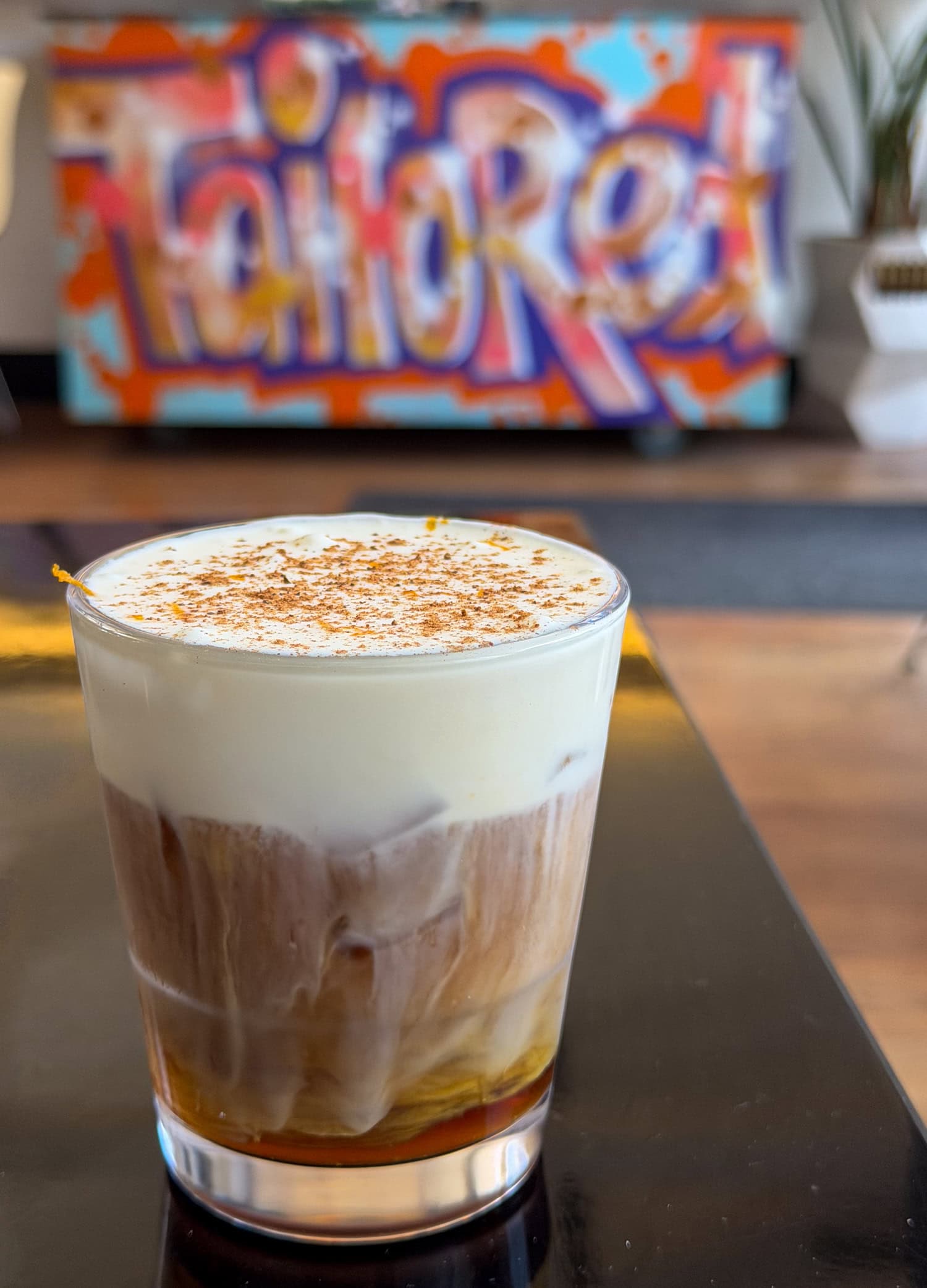 Iced Channel Orange coffee with orange cold foam at Tailored Coffee Roasters in Eugene, Oregon.