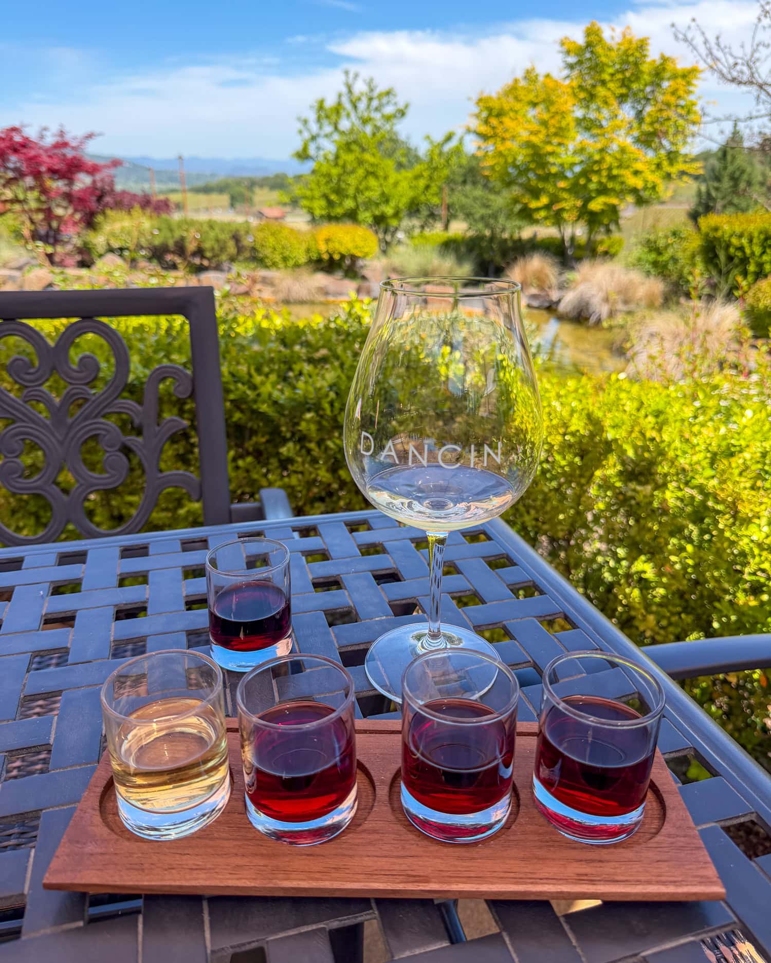 DANCIN wine flight on a patio table overlooking the koi pond