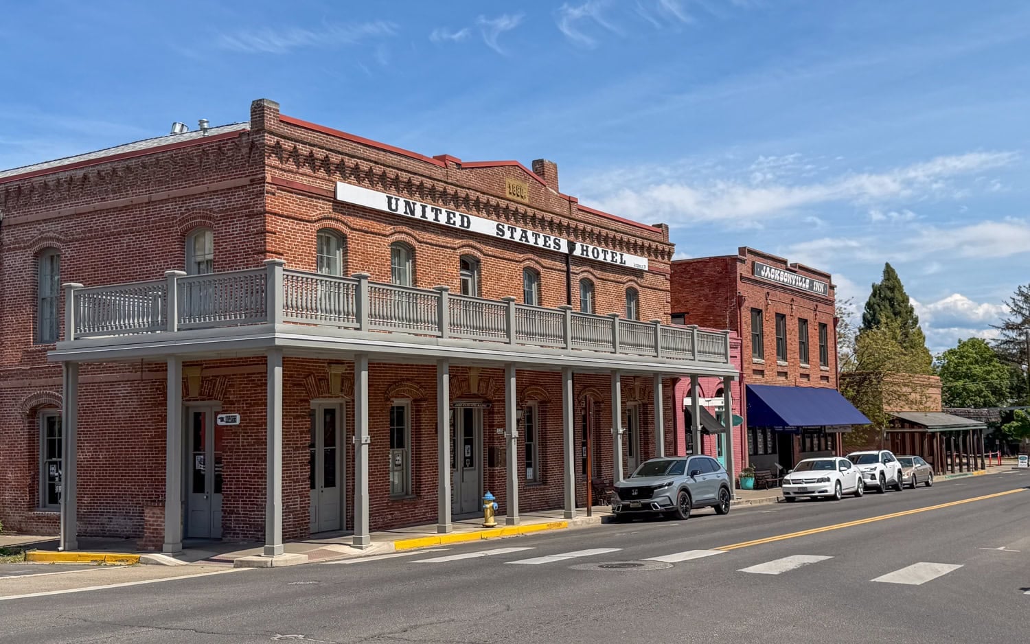 Historic brick buildings along a street in downtown Jacksonville, Oregon